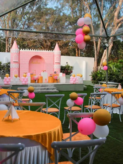 A princess-themed birthday party at The Backyard. The pink castle backdrop and balloon decorations create a magical setting for a child's special day.