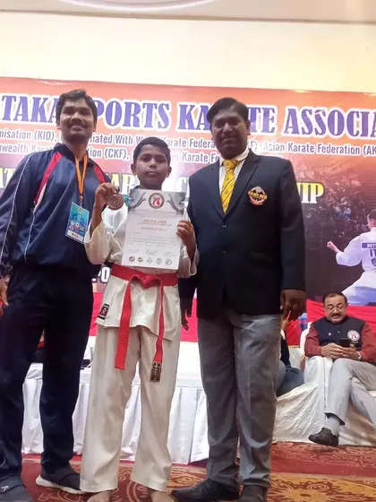 Another photo celebrating a student's victory at the state championship in Hubli.