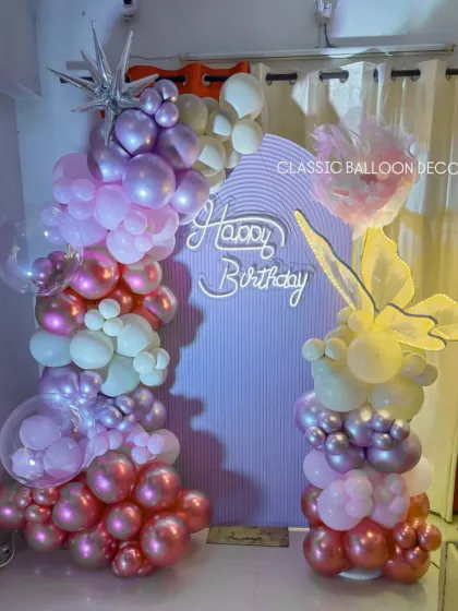 A closer view of the 40th birthday decor, highlighting the mix of balloon textures and the glowing neon sign.