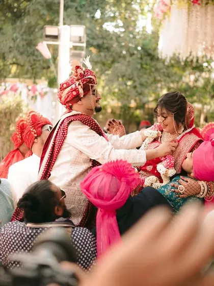 A fun and unique wedding tradition where the groom is lifted by his friends during the Varmala ceremony.