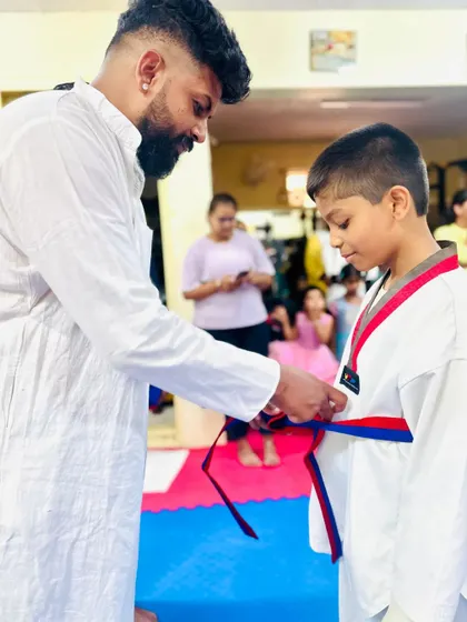 Another student earns his red and blue belt through dedication and practice.