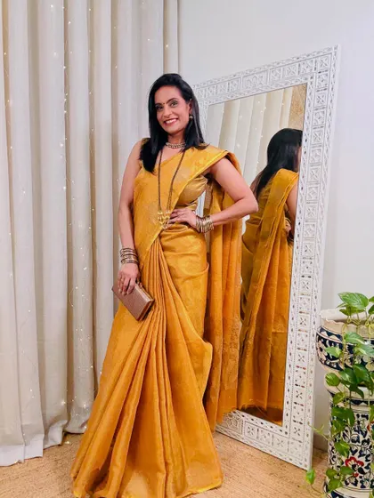 This mustard yellow tissue saree is perfect for a festive occasion. The fabric has a beautiful sheen that catches the light, making you glow.