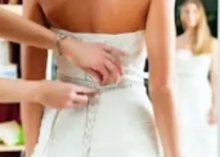 A perfect fit requires precise measurements. Here, I am taking detailed measurements for a wedding gown to ensure the back and waist fit the bride's body exactly, providing both comfort and a beautiful silhouette.