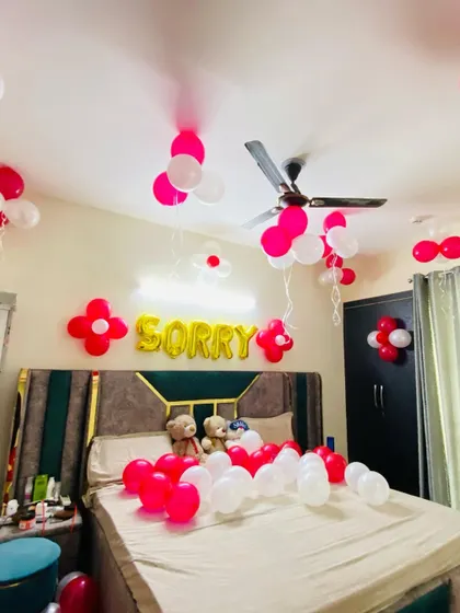 A unique "Sorry" decoration to help you apologize in a special way. The setup includes pink and white balloons and gold foil letters.