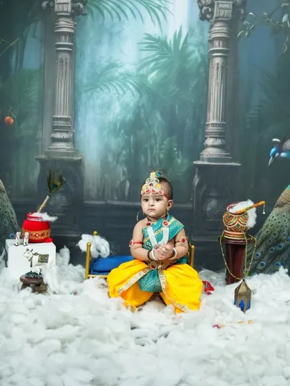 A wider view of the Krishna setup, featuring majestic pillars, peacock props, and a 'dahi handi', creating a mythical forest scene right in my Vashi studio.