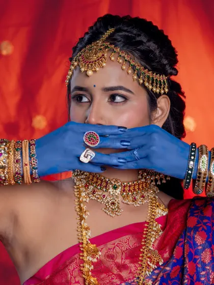 A creative shot that draws attention to the intricate details of the choker and the colourful bangles.