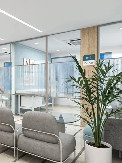 A closer view of the Central Park Polyclinic waiting area, highlighting the use of frosted glass partitions for privacy and potted plants to enhance the connection to nature.