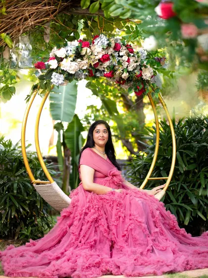 A beautiful, serene portrait on the floral swing. This setup allows for elegant and relaxed poses that highlight the beauty of pregnancy.