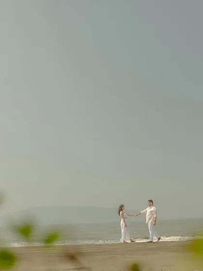 A beautifully framed shot using natural foliage to create depth. This technique adds an artistic and intimate feel to your outdoor couple portraits.
