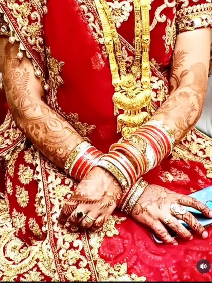 A bride in her red wedding dress, with her beautifully stained hands holding a phone. A modern bridal moment!