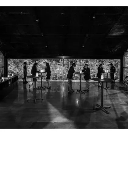 A black and white photograph of the Durall Pavilion. The temporary structure was designed as a place of pause and quiet introspection amidst the noise of a large product exhibition.