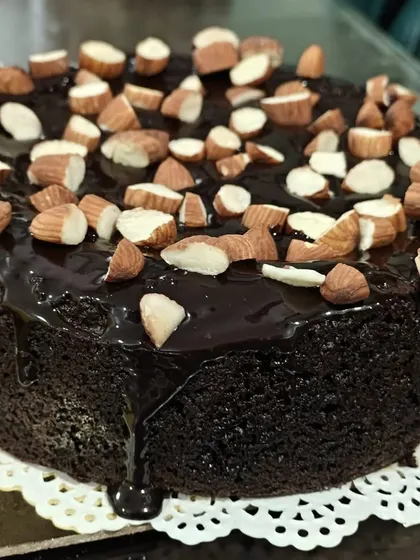 This rich chocolate cake, topped with crunchy almonds, strikes the perfect balance between health and indulgence. It's made without sugar, maida, or butter.