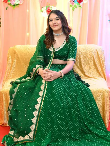 Dhruvi seated and looking serene during her Kankotri function. The soft makeup ensures she looks comfortable and beautiful throughout the ceremonies.