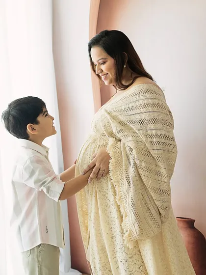 The look of love between a mother and her firstborn as they anticipate the new baby. The soft, natural light adds to the warmth of the scene.