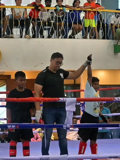 The referee raises the hand of our young fighter. A proud moment for him, his family, and our entire team.