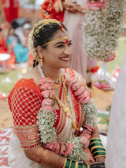 The happy smile of a bride during her wedding rituals. The makeup is sweat-proof and long-lasting, keeping her looking perfect throughout the day.