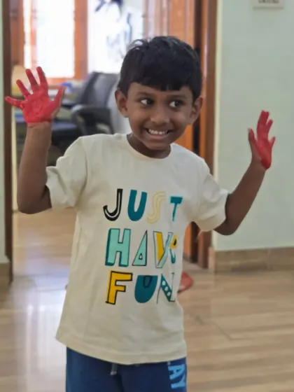 A joyful moment captured during our hand printing session. His t-shirt says "Just Have Fun," and that is exactly what we do at our summer camp.