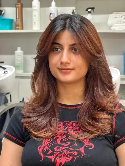 Adding dimension and softness with a new haircut and color. She looks refreshed and confident with her new style.