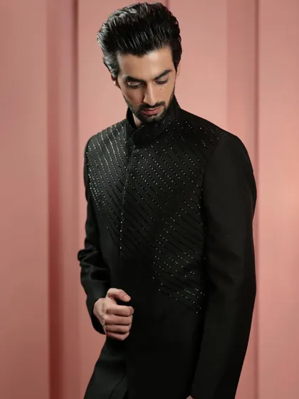 Another view of the black beaded Indo-Western jacket, showing its sleek silhouette from a different angle. It's a testament to understated elegance.