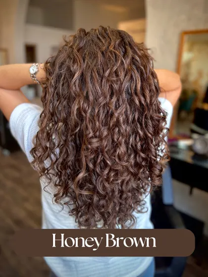 A beautiful Honey Brown color on these defined curls. The warm tones add a sun-kissed glow and make the texture pop.