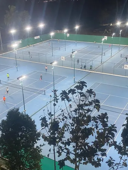 Tennis never stops at our academy. This shot captures a busy evening session under the floodlights, showcasing the dedication of our players and our commitment to providing round-the-clock training opportunities.
