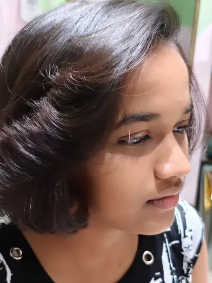A side view of the beautiful short bob haircut, showcasing its clean lines and modern shape.