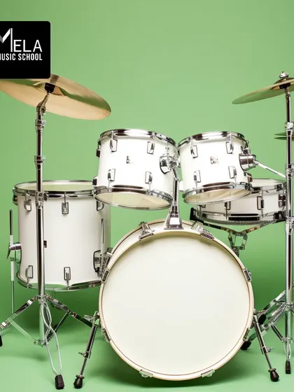 A classic white drum kit, ready for a rock session. We teach various genres, from rock and pop to jazz and funk.