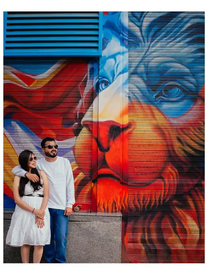 A bold and vibrant urban shot with colorful street art as the backdrop. We love incorporating the city's creative energy into our pre-wedding photoshoots.
