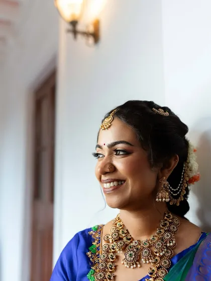 Another angle of this radiant bride, showing how the makeup catches the light to create a beautiful glow. The look is timeless and elegant.