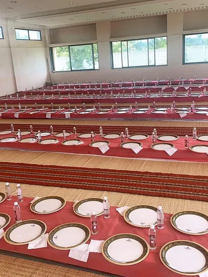 A pre-event shot showing the scale of our floor-seating arrangement for a large community meal, with every place setting perfectly arranged.