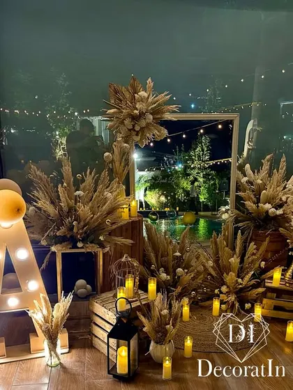 The full rustic photo corner at night, with the marquee 'A' and all the candles lit, creating a truly magical and cozy vibe.