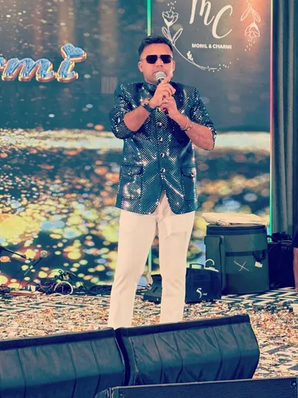 With the mic in my hand and the couple's name shining bright, I'm ready to get the party started. My focus is always on the audience, making sure they are as much a part of the show as the performers.