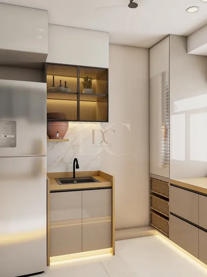 This kitchen design focuses on maximizing storage and maintaining a clean aesthetic. Notice the tall unit next to the fridge, the glass-front cabinet for display, and the warm under-cabinet lighting that highlights the workspace.