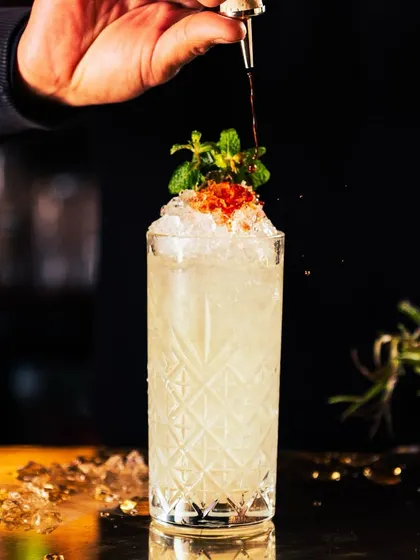 Living the weekend feeling one cocktail at a time. This refreshing highball, garnished with mint and caviar-like pearls, is an escape to a world of exquisite taste.