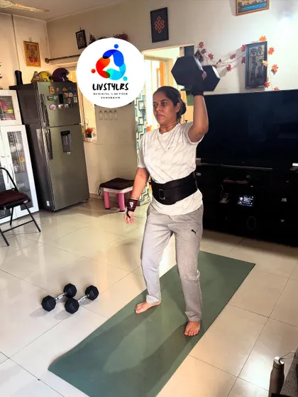 A client performs a single-arm overhead press with a dumbbell. This exercise is great for building shoulder strength and stability, an important part of a balanced fitness routine.