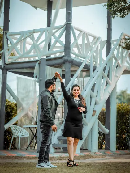 A joyful and dynamic shot of the couple dancing, capturing movement and happiness in their pre-wedding photos.