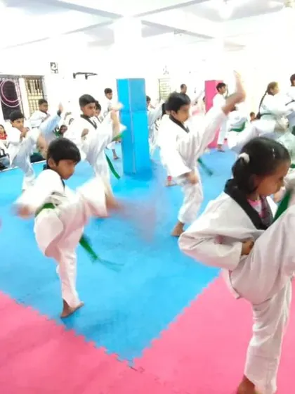 A class of green belts practicing their kicks.