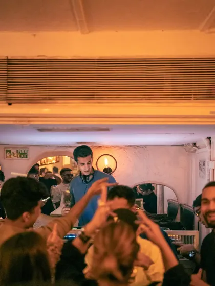 A view from the crowd at Olive, looking up at the DJ booth. It's an intimate venue that creates a great connection.