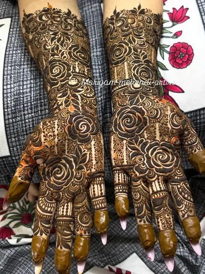 A bold Dubai floral mehendi with prominent rose motifs and intricate shading.