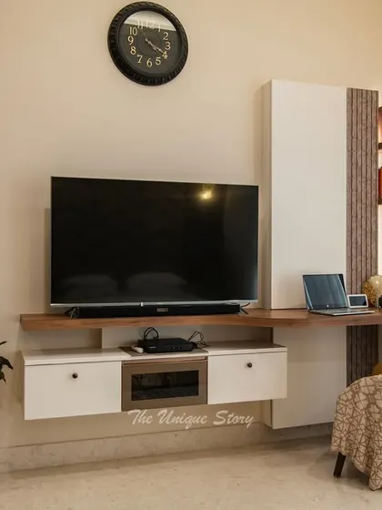 This image showcases a multi-functional wall unit that combines a floating TV console with an integrated work desk. This space-saving design is perfect for modern bedrooms where functionality is key.