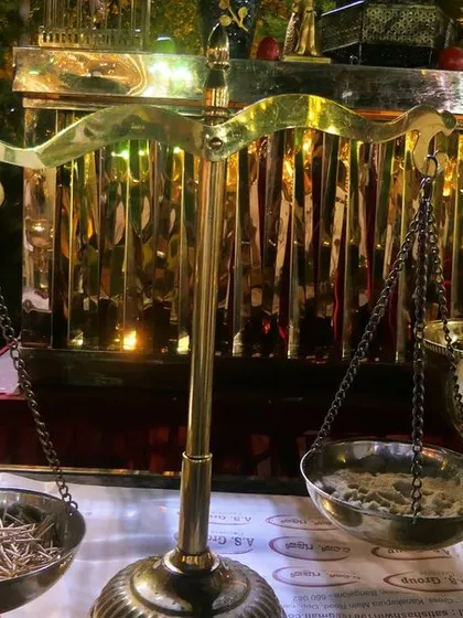 A decorative brass scale adds a vintage and rustic charm to this food counter. I use unique decor elements to match the theme of your event.