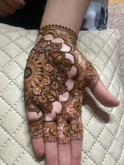 A wider view of the palm with the central mandala, surrounded by delicate floral patterns.