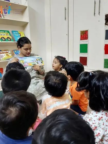 Children gather around their teacher, listening intently to a story about the birth of Lord Krishna. These sessions create a sense of community and shared experience.