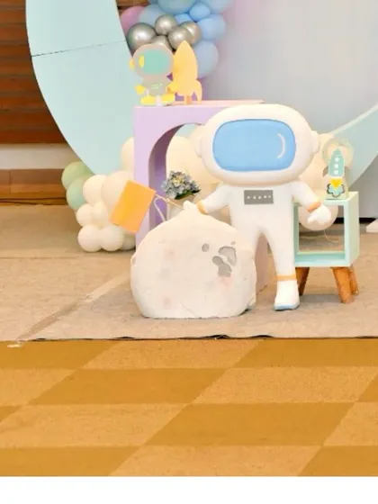 A plush astronaut prop, perfect for a 'First Trip Around the Sun' or space-themed party.