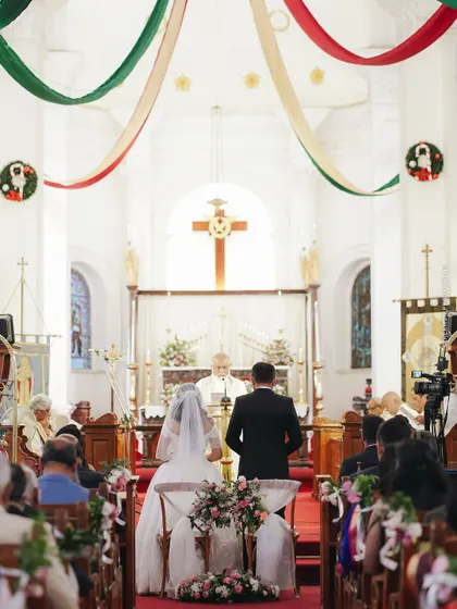 A classic church wedding scene, with the couple at the altar before the priest and their loved ones. I coordinate with venues of all kinds, including places of worship, to ensure a seamless ceremony.