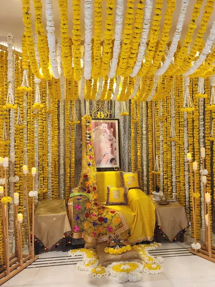 A beautiful satsang evening at home, decorated with walls of yellow and white marigold garlands and dozens of glowing candles for a truly blessed and serene atmosphere.