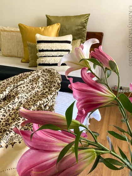 My happy place. A bed layered with textures and colours, featuring my Scandi-Boho loop cushion in black and cream.