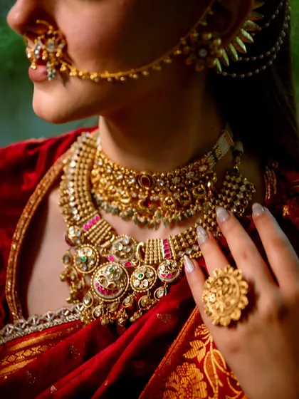 A detailed shot of the exquisite jewelry and the flawless makeup base. I ensure the skin looks smooth and radiant, providing the perfect canvas for such stunning traditional adornments.