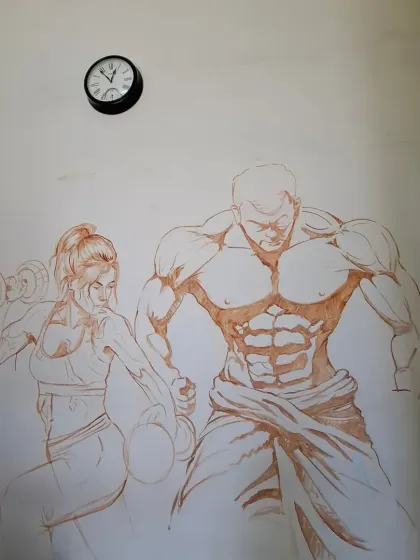 The initial outline sketch of the gym mural on the wall. This is the foundational step before we start adding layers of color.