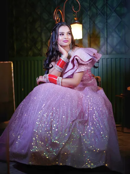 A seated portrait in the pink sequin gown, showing its beautiful sparkle in a different light.